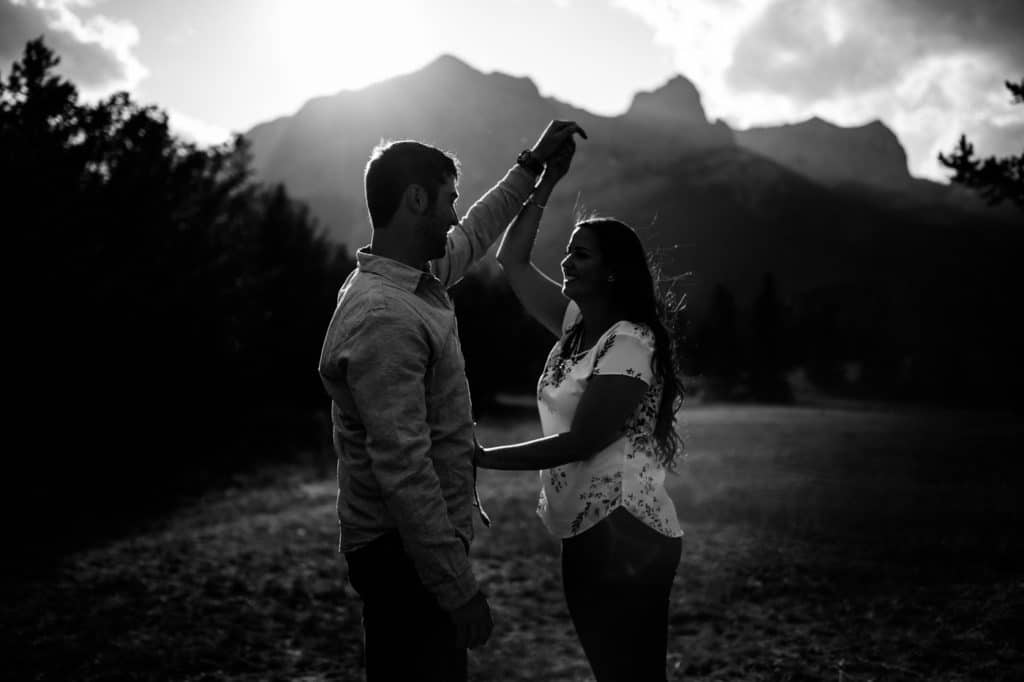 Mount Rundle engagement shoot with engaged couple dancing and having fun together