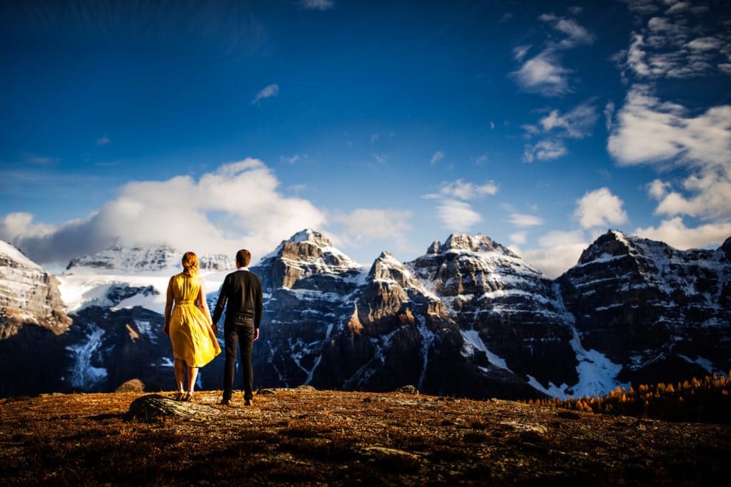 An engaged couple are being photographed at the Valley Of The Ten Peak located close to Moraine Lake