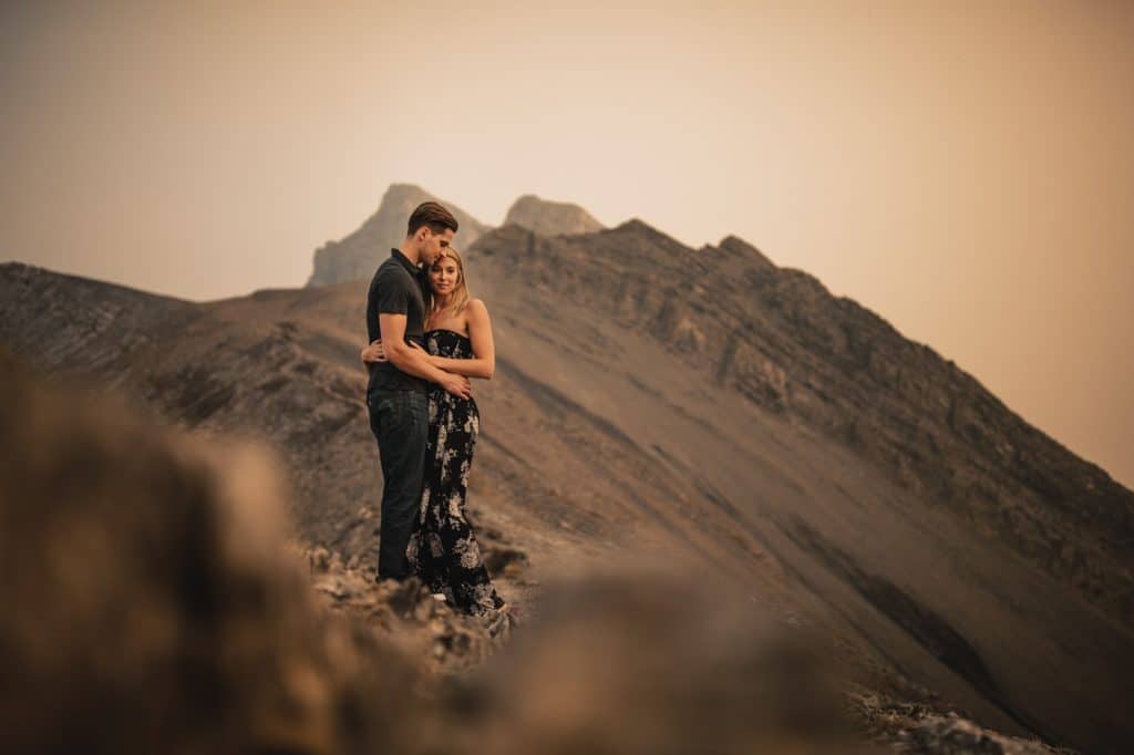 Ha-Ling adventure engagement shoot with the couple hiking to the top of the mountains during Banff The Canadian Rockies forest fires