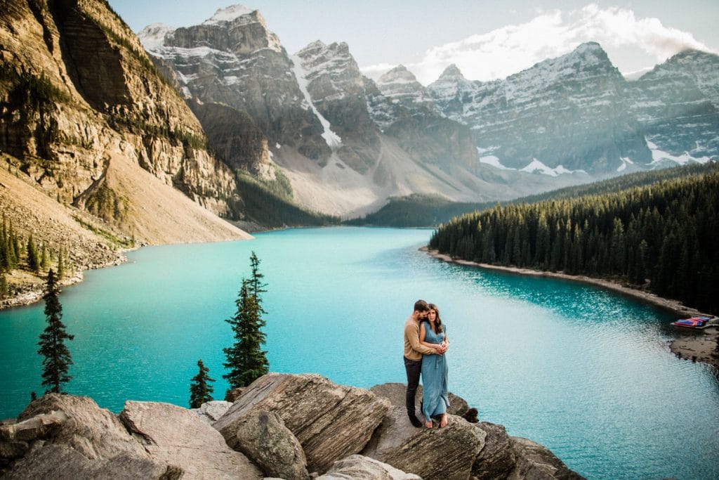 A couple shoot located at Moraine Lake with the valley of the ten peak in the background