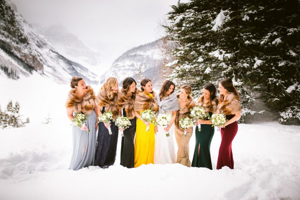 Winter bridal photograph at Lake Louise with bride and her best friends laughing during an incredible Lake Louise wedding
