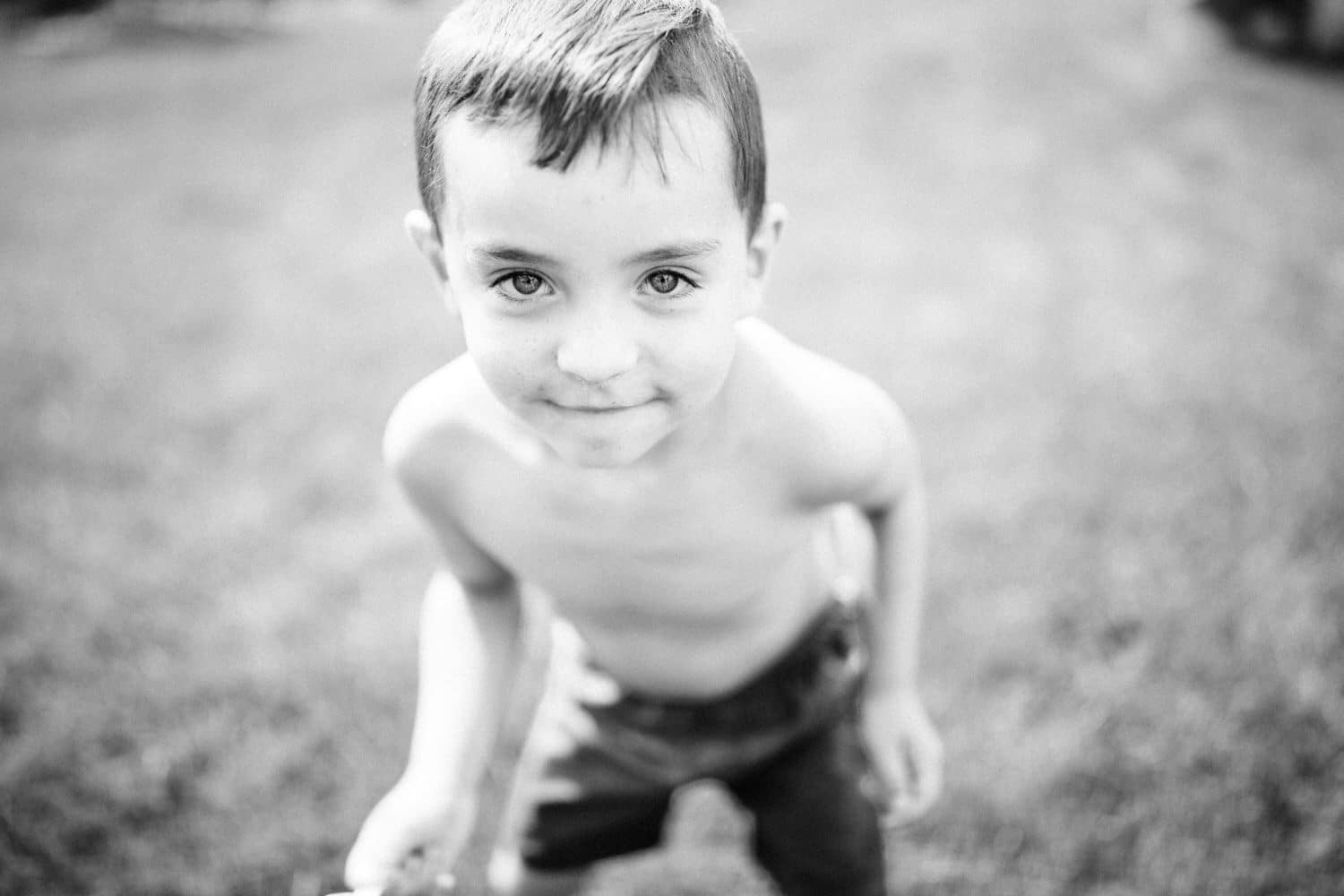 boy playing in his backyard and looked up to the camera for a photograph to be taken