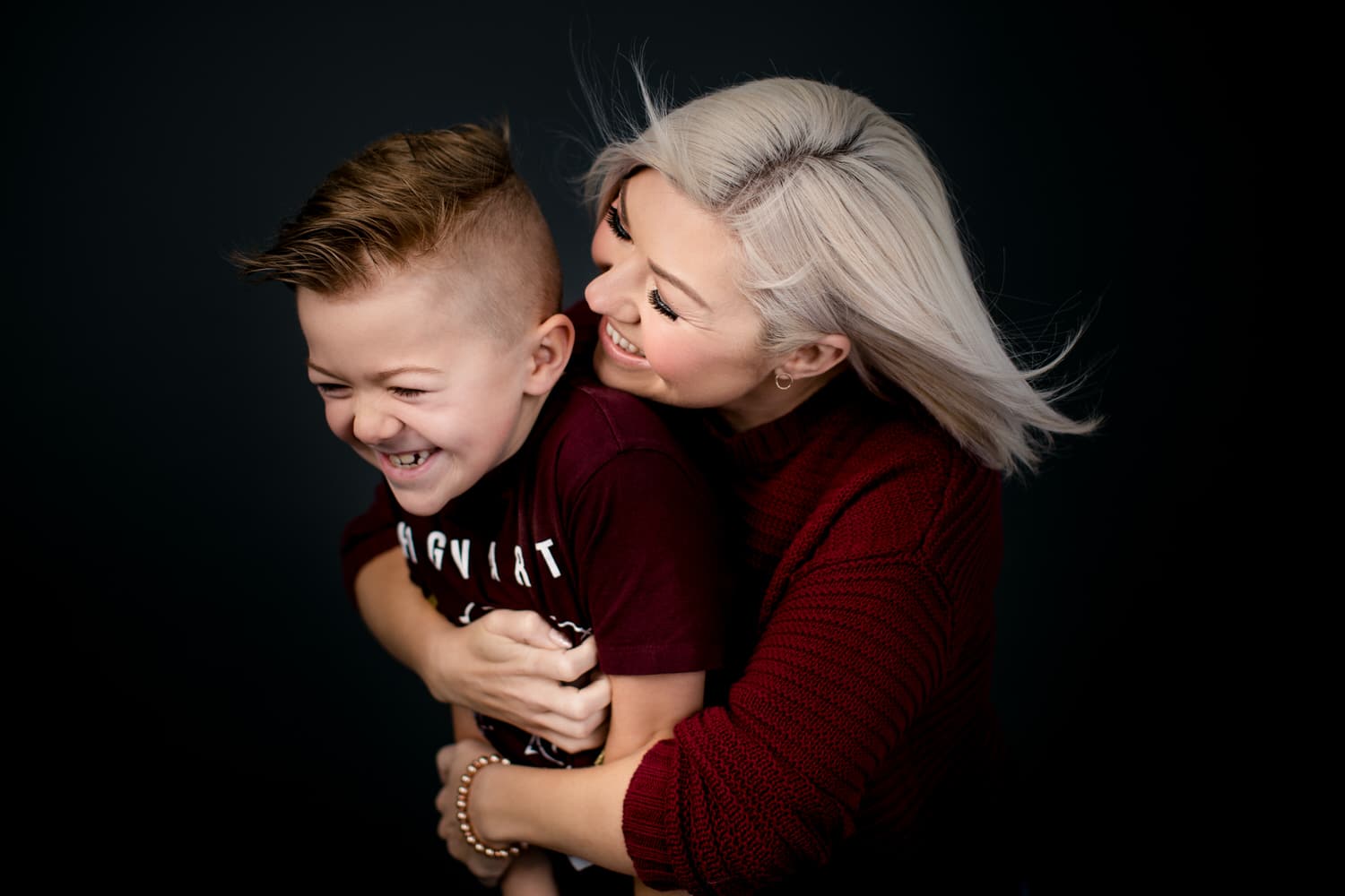 Mom holding her son in Calgary during a professional studio photograph session