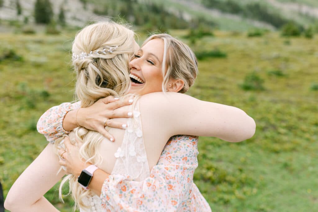 Bride and best friend hugging after she got married