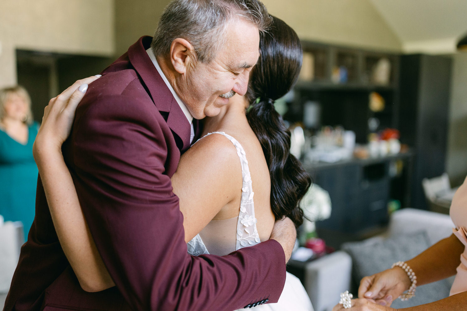 A heartfelt moment between a father and daughter as they share an emotional hug, celebrating the special day ahead.