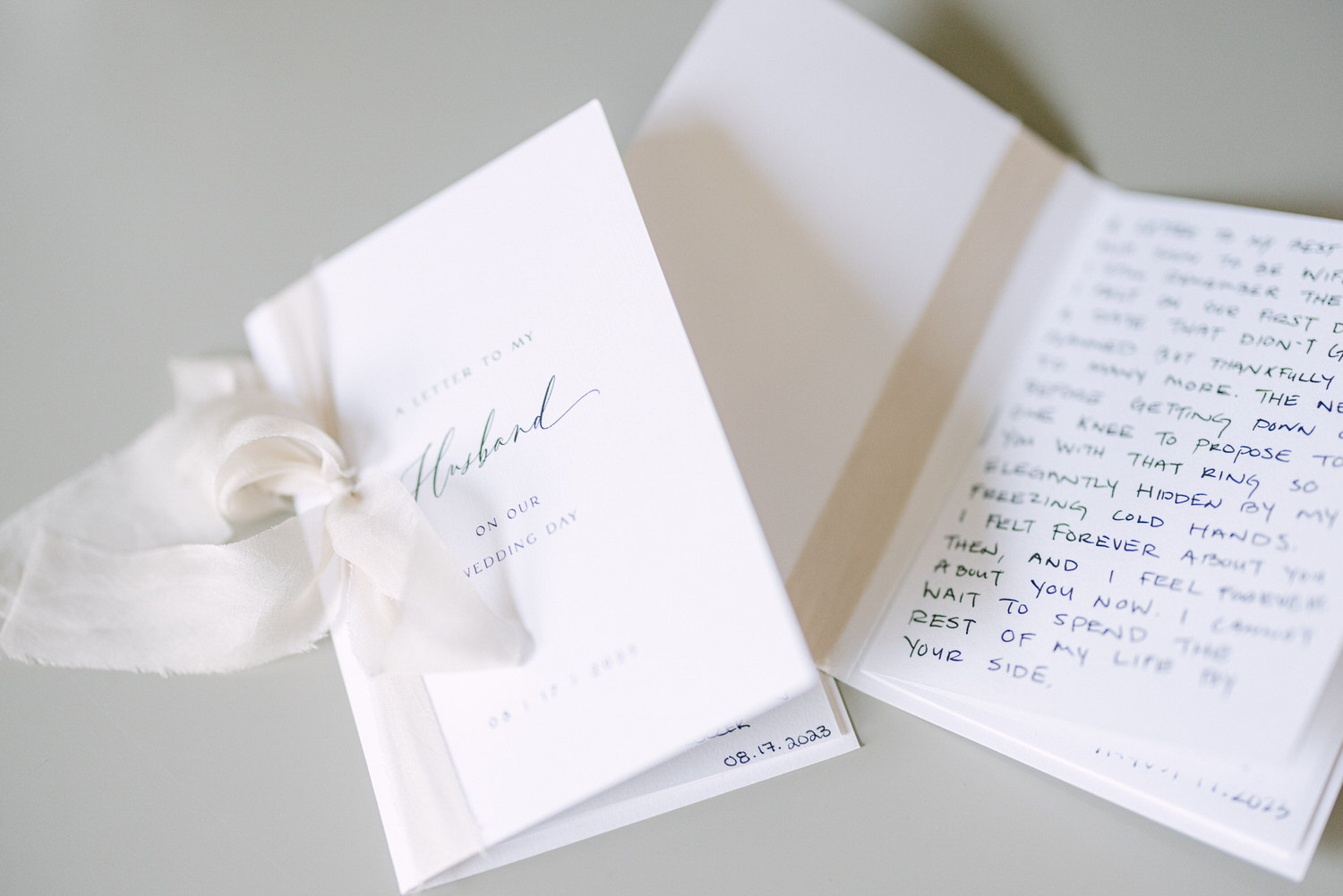 A beautifully crafted letter with a delicate ribbon, featuring heartfelt messages for a husband on their wedding day, partially visible text inside.