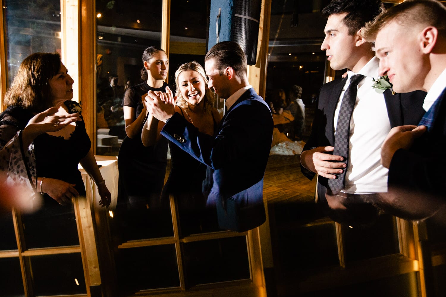 A group of friends enjoying a lively moment at a party, with smiles and interactions in a festive setting.