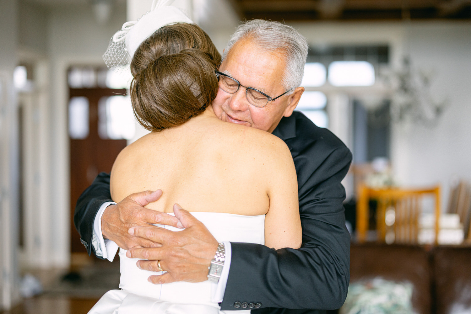 A touching moment captured between a father and his daughter as they share a heartfelt hug, emphasizing love and connection on a special day.