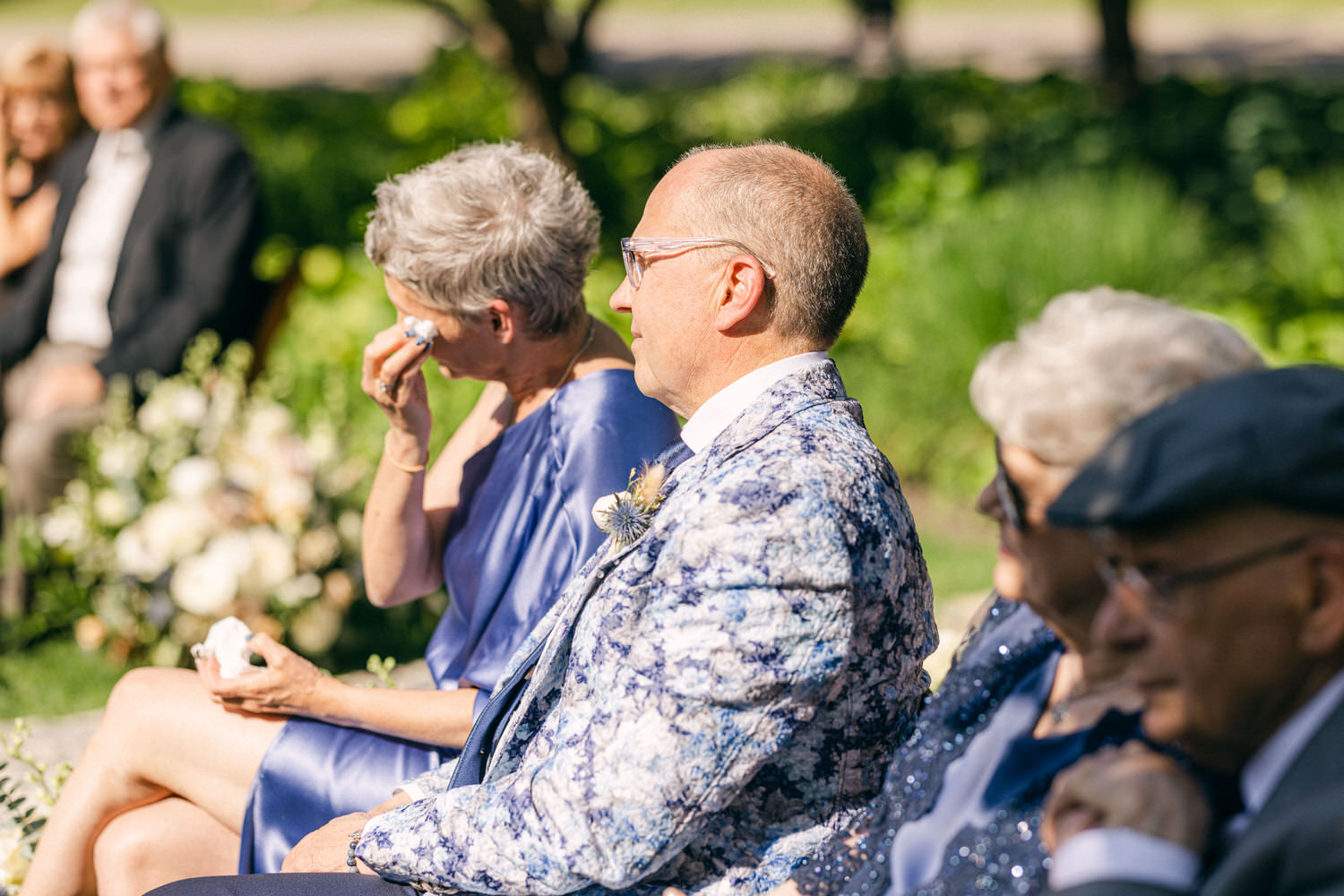 Guests experiencing heartfelt emotions during a wedding, showcasing a mix of joy and tears.