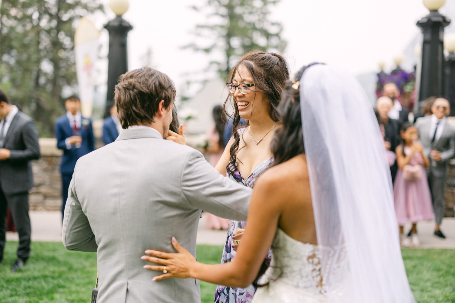 Two guests share a joyful moment at a wedding, showcasing smiles and celebratory interactions amidst a festive atmosphere.