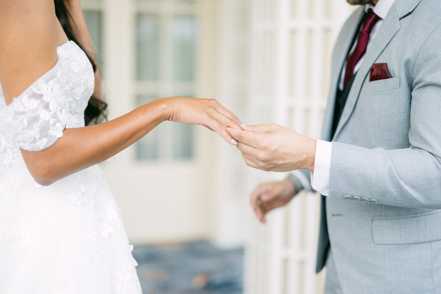 A close-up of a bride and groom exchanging rings during their wedding ceremony, capturing the moment of unity and commitment.