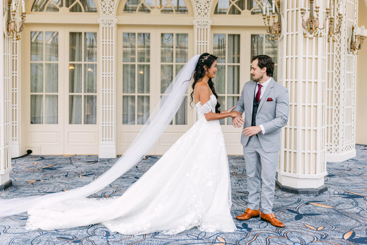 Bride and groom exchange heartfelt moments in a beautifully decorated setting, showcasing intricate details and a romantic ambiance.