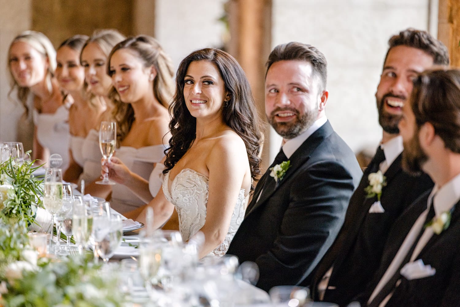 Bridal party enjoying a joyful moment during a wedding reception.