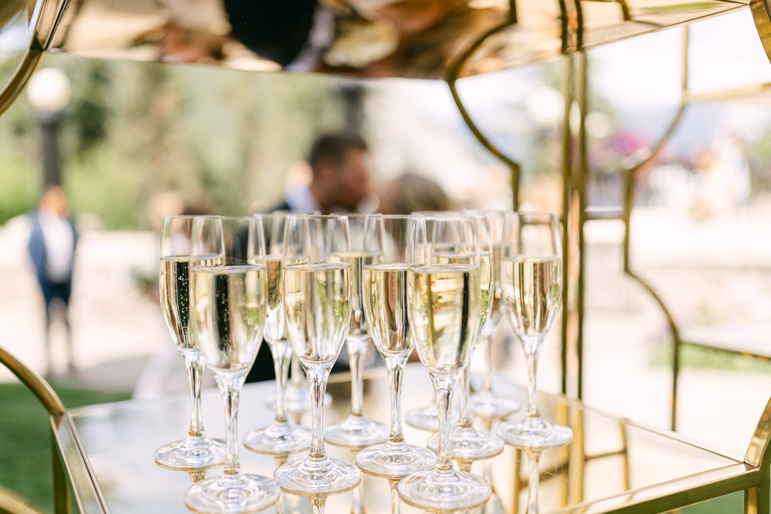 Elegant champagne flutes filled with sparkling wine on a golden display, capturing a moment of festivity.