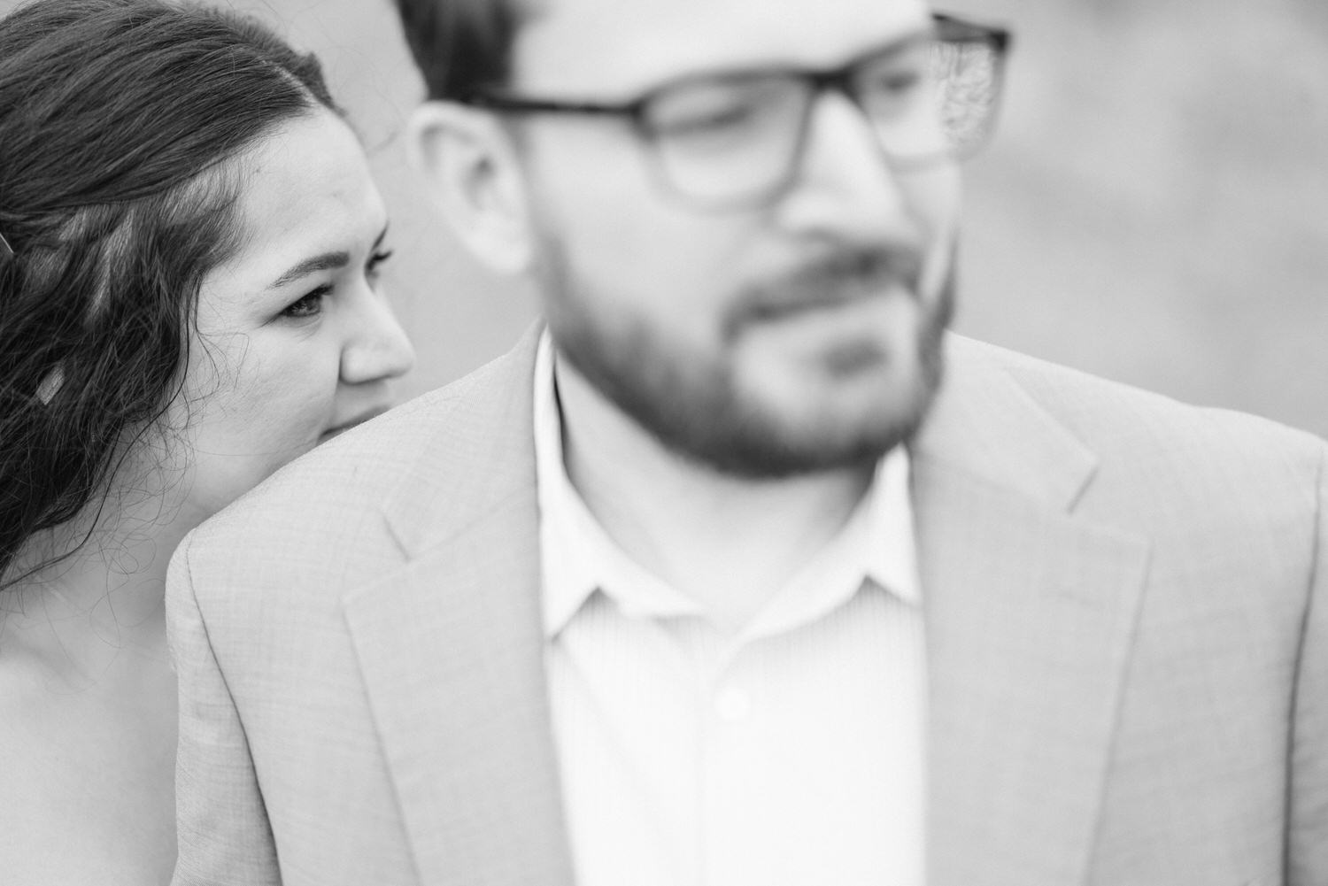 A close-up shot of a couple, with one partner nuzzling the shoulder of the other, conveying a sense of affection and connection.