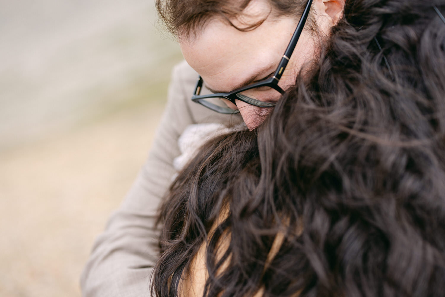 Close-up of two people sharing a tender moment, their faces partially hidden, showcasing a sense of love and connection.